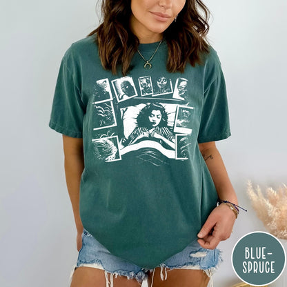Comfort Colors tee in Blue Spruce featuring graphic style illustration of a woman sleeping surrounded by horror polaroids