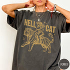 Comfort Colors tee in Pepper featuring western style graphic of a cowgirl riding a large tiger