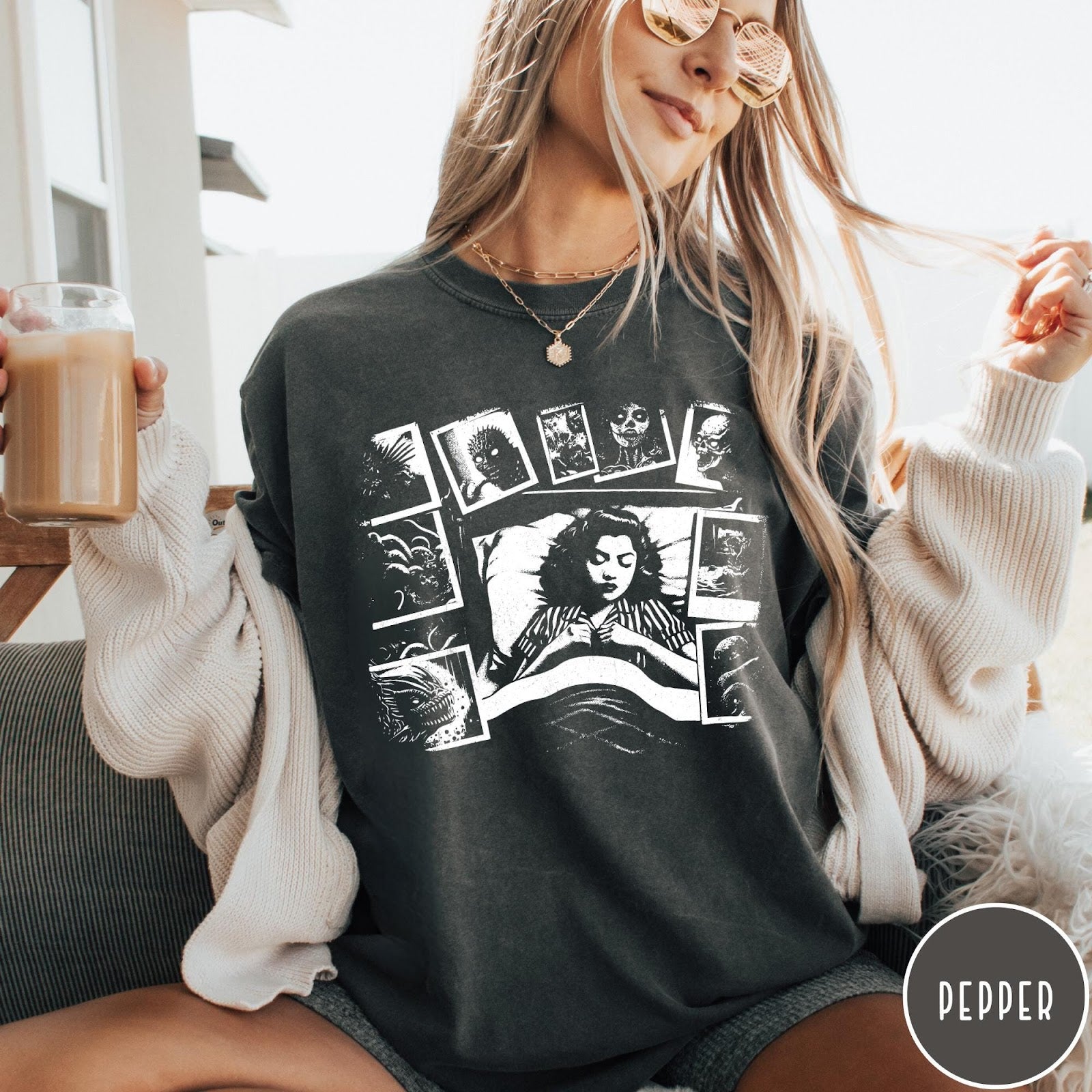 Comfort Colors tee in Pepper featuring graphic style illustration of a woman sleeping surrounded by horror polaroids