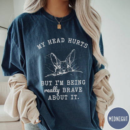 Comfort Colors tee in Midnight featuring line art graphic of a bunny resting its head on a pillow