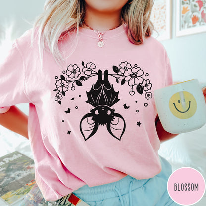 Comfort Colors tee in Blossom featuring line art style upside down bat graphic with surrounding floral elements