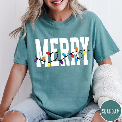 Comfort Colors tee in Seafoam featuring festive holiday style graphic with Merry text and Christmas lights