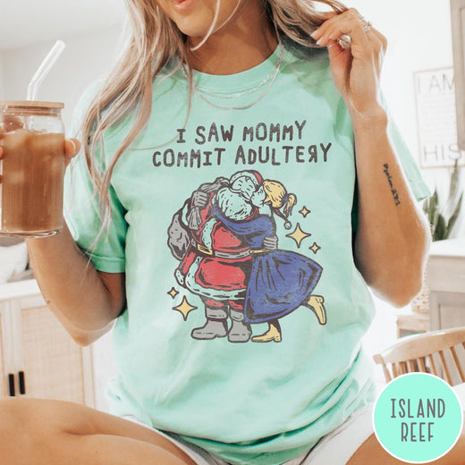 Comfort Colors tee in Island Reef featuring vintage style graphic of Santa Claus kissing a woman under stars