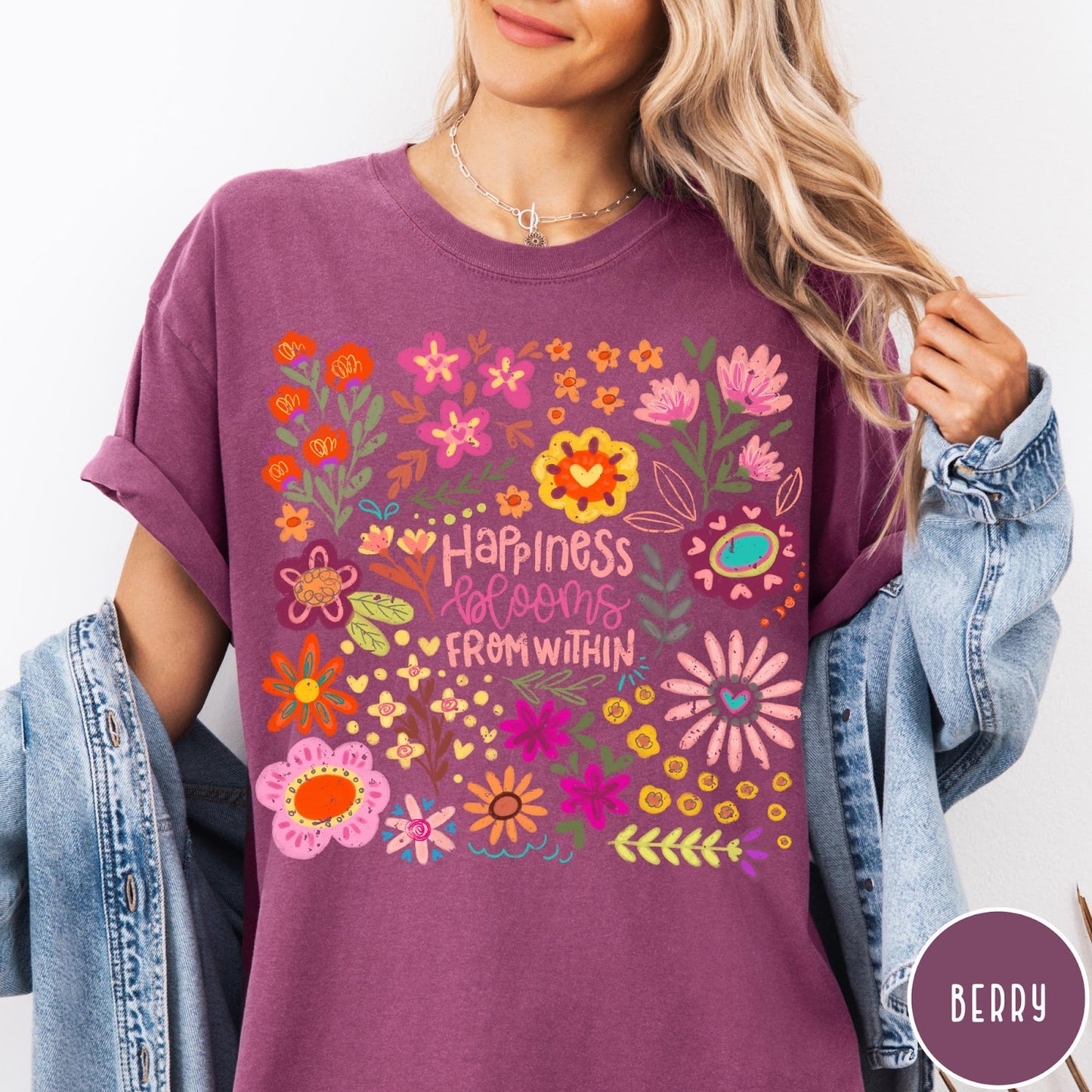 Comfort Colors tee in Berry featuring floral wildflowers design with Happiness Blooms Within text graphic description