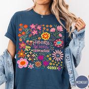 Comfort Colors tee in Midnight featuring floral wildflowers design with Happiness Blooms Within text graphic description
