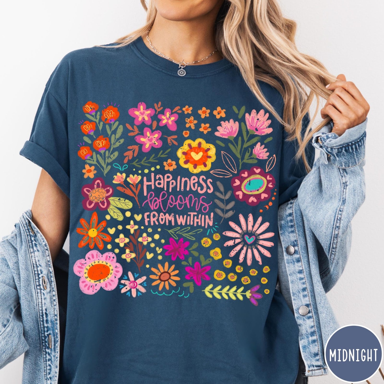 Comfort Colors tee in Midnight featuring floral wildflowers design with Happiness Blooms Within text graphic description