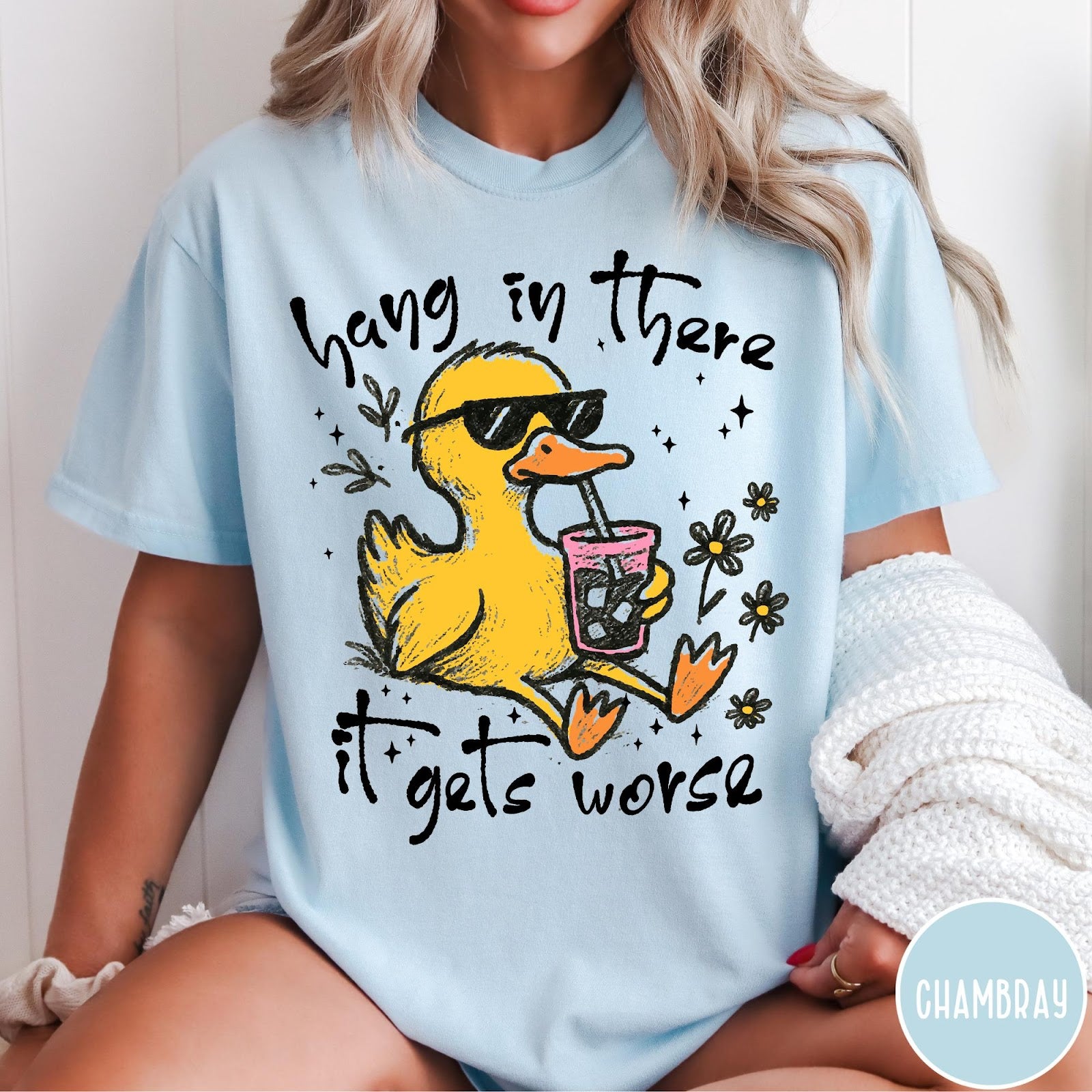 Comfort Colors tee in Chambray featuring illustrated duck graphic wearing sunglasses and drinking a pink iced beverage