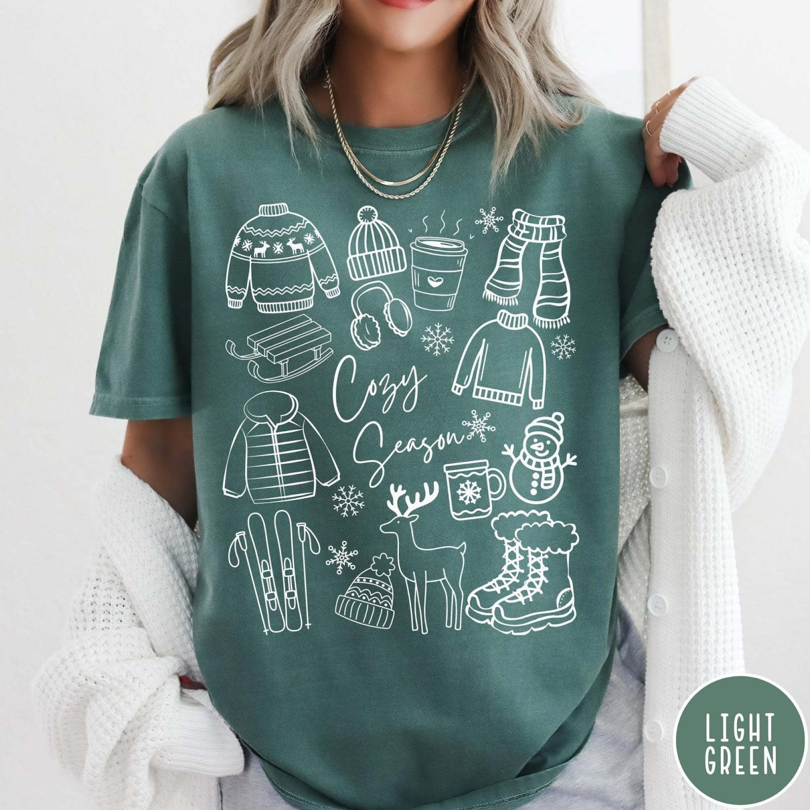Comfort Colors tee in Light Green featuring line art winter activities and seasonal items graphic design