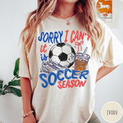 Comfort Colors tee in Ivory featuring screen print style soccer season graphic with ball and iced coffee