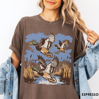 Comfort Colors tee in Espresso featuring vintage style mallard ducks flying over a marshy pond graphic