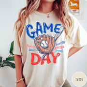 Comfort Colors tee in Ivory featuring baseball design with glove, ball, bat, and Game Day text graphic