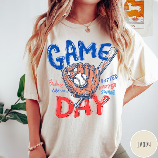 Comfort Colors tee in Ivory featuring baseball design with glove, ball, bat, and Game Day text graphic