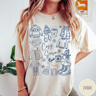 Comfort Colors tee in Ivory featuring line art winter activities and seasonal items graphic design