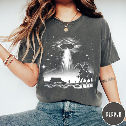 Comfort Colors tee in Pepper featuring western graphic style with a cowboy riding a horse under a UFO