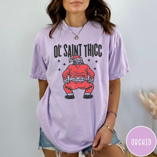 Comfort Colors tee in Orchid featuring festive graphic style Santa Claus doing a dance move with stars