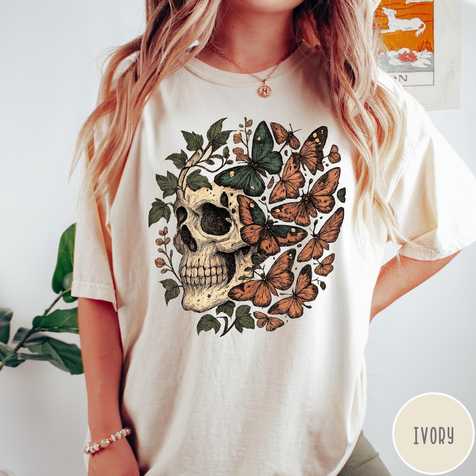 Comfort Colors tee in Ivory featuring vintage style graphic with a skull surrounded by various colorful butterflies