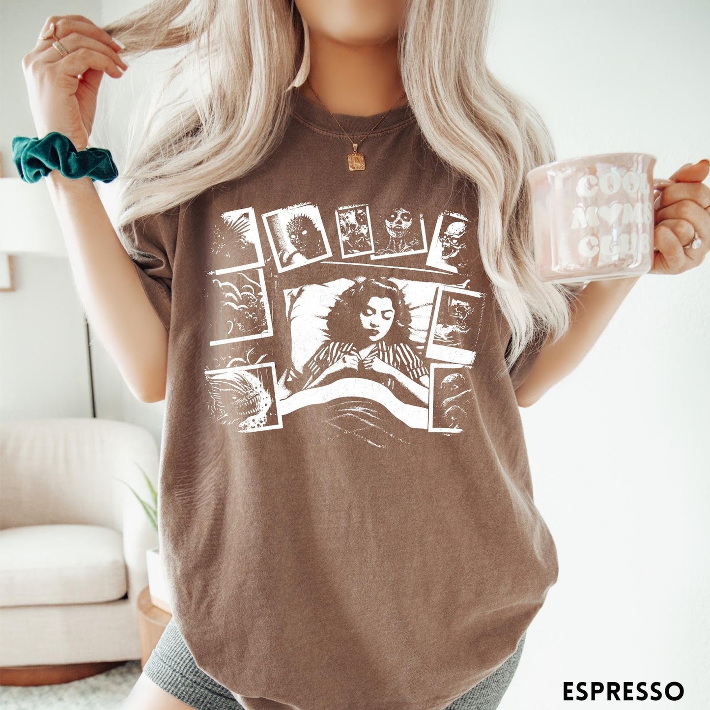 Comfort Colors tee in Espresso featuring graphic style illustration of a woman sleeping surrounded by horror polaroids