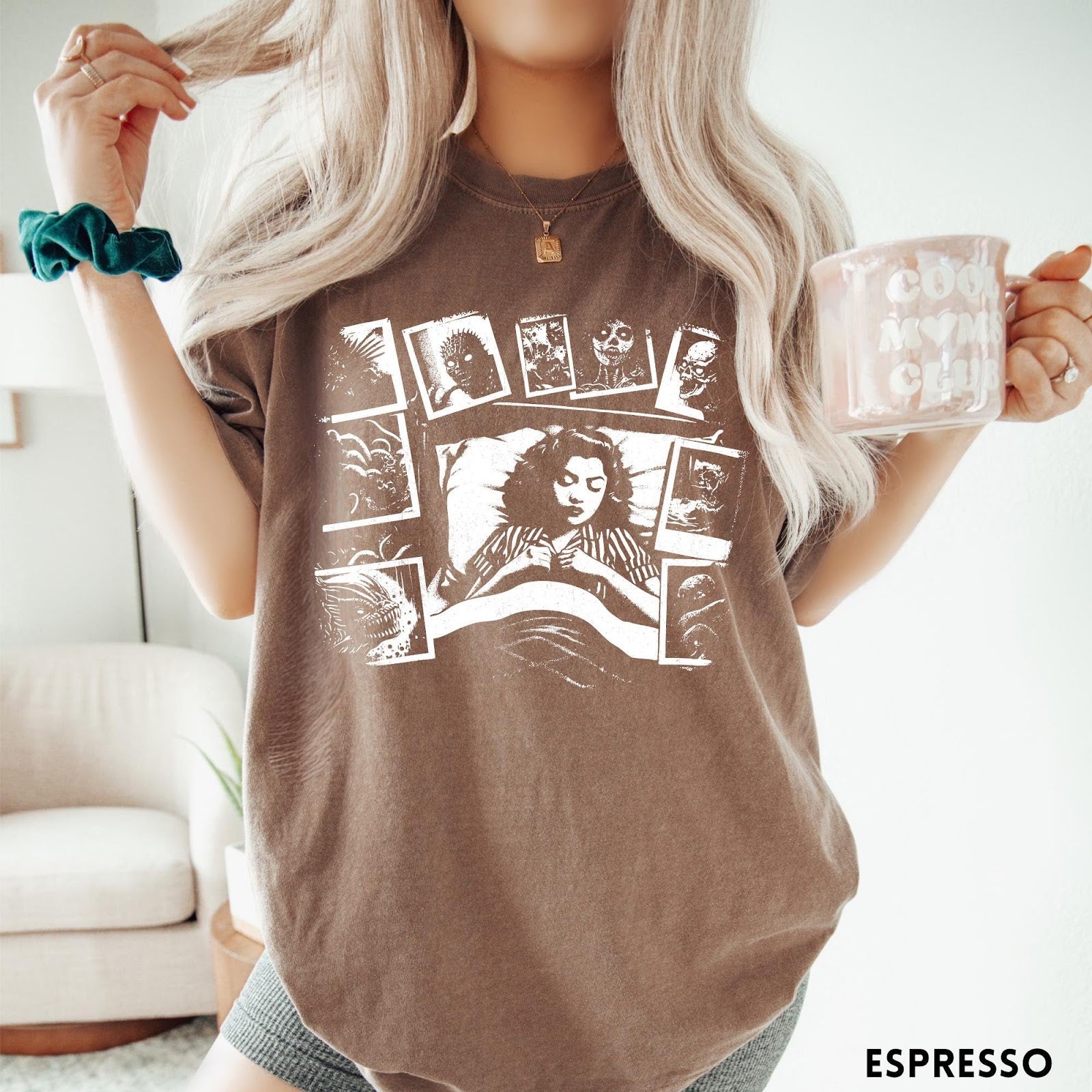Comfort Colors tee in Espresso featuring graphic style illustration of a woman sleeping surrounded by horror polaroids