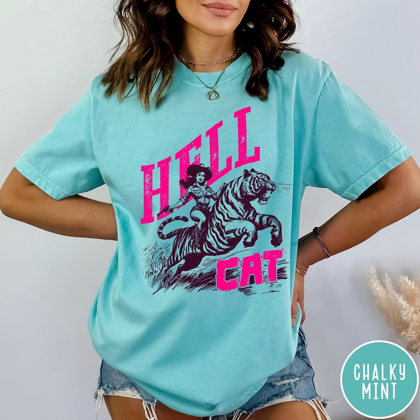 Comfort Colors tee in Chalky Mint featuring retro design of a cowgirl riding a tiger with pink text