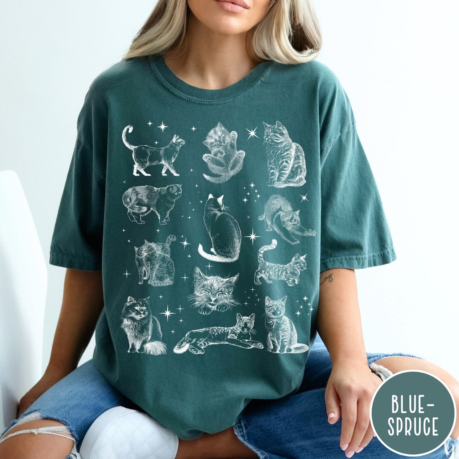 Comfort Colors tee in Blue Spruce featuring vintage style graphic illustration of various cats and celestial stars
