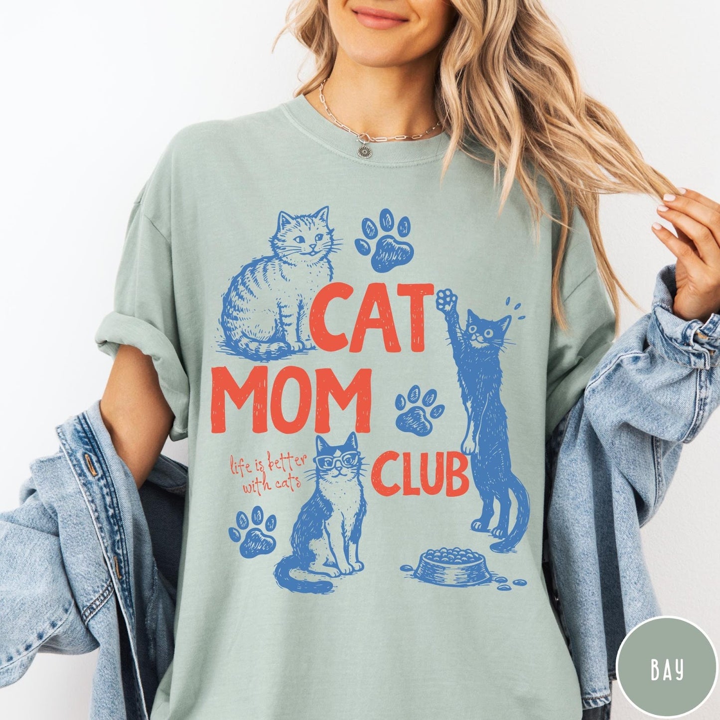 Comfort Colors tee in Bay featuring graphic illustration of cats, paw prints, and Cat Mom Club text