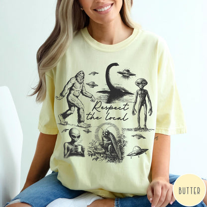 Comfort Colors tee in Butter featuring vintage style cryptid graphic with Bigfoot, UFOs, and alien creatures.