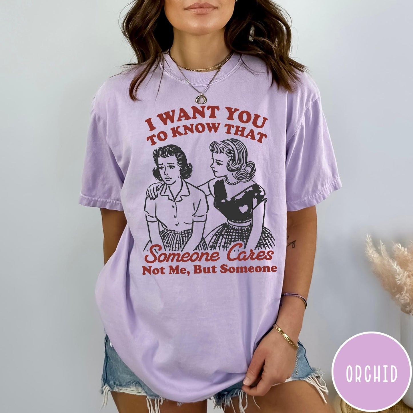 Comfort Colors tee in Orchid featuring vintage style graphic of two women comforting each other with text