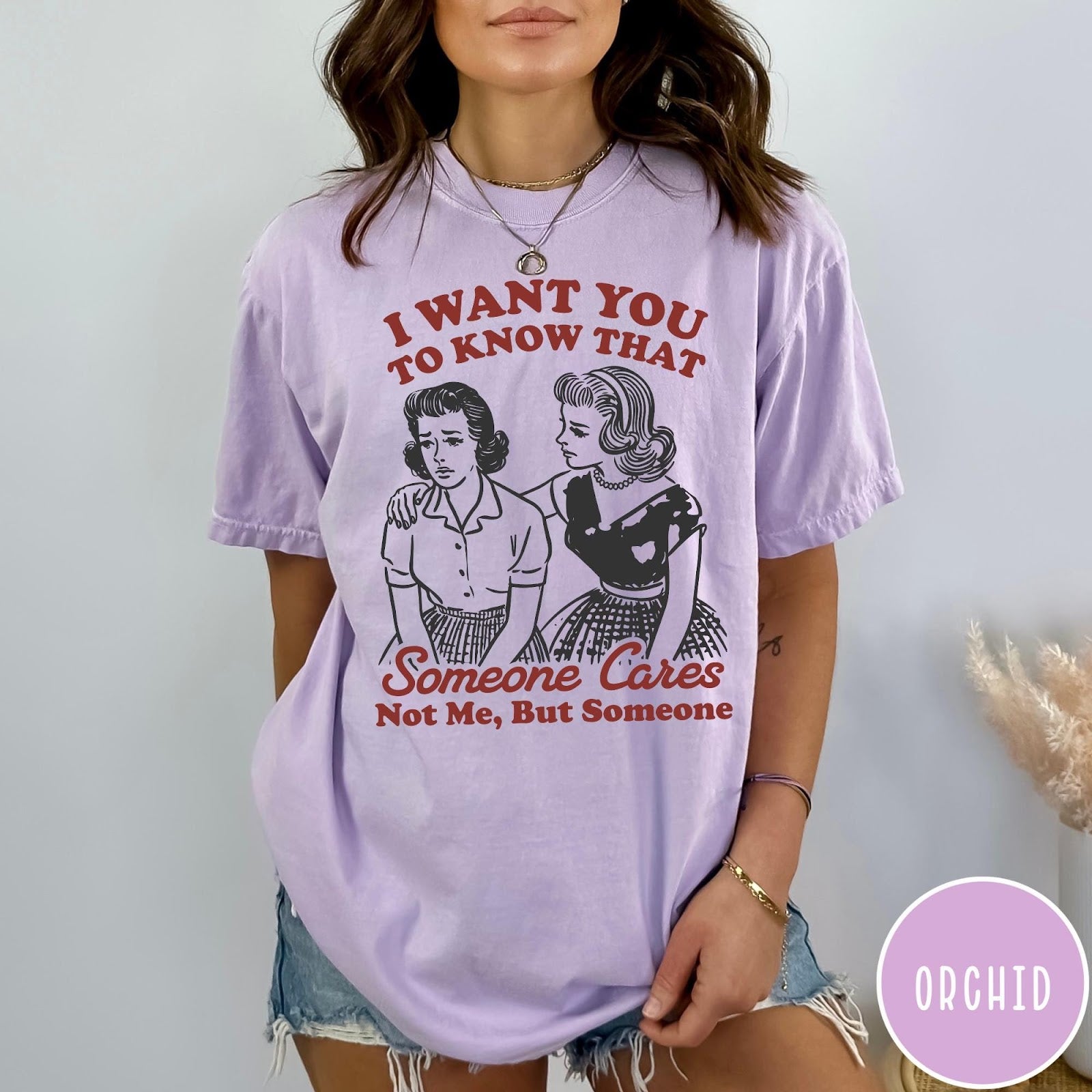 Comfort Colors tee in Orchid featuring vintage style graphic of two women comforting each other with text