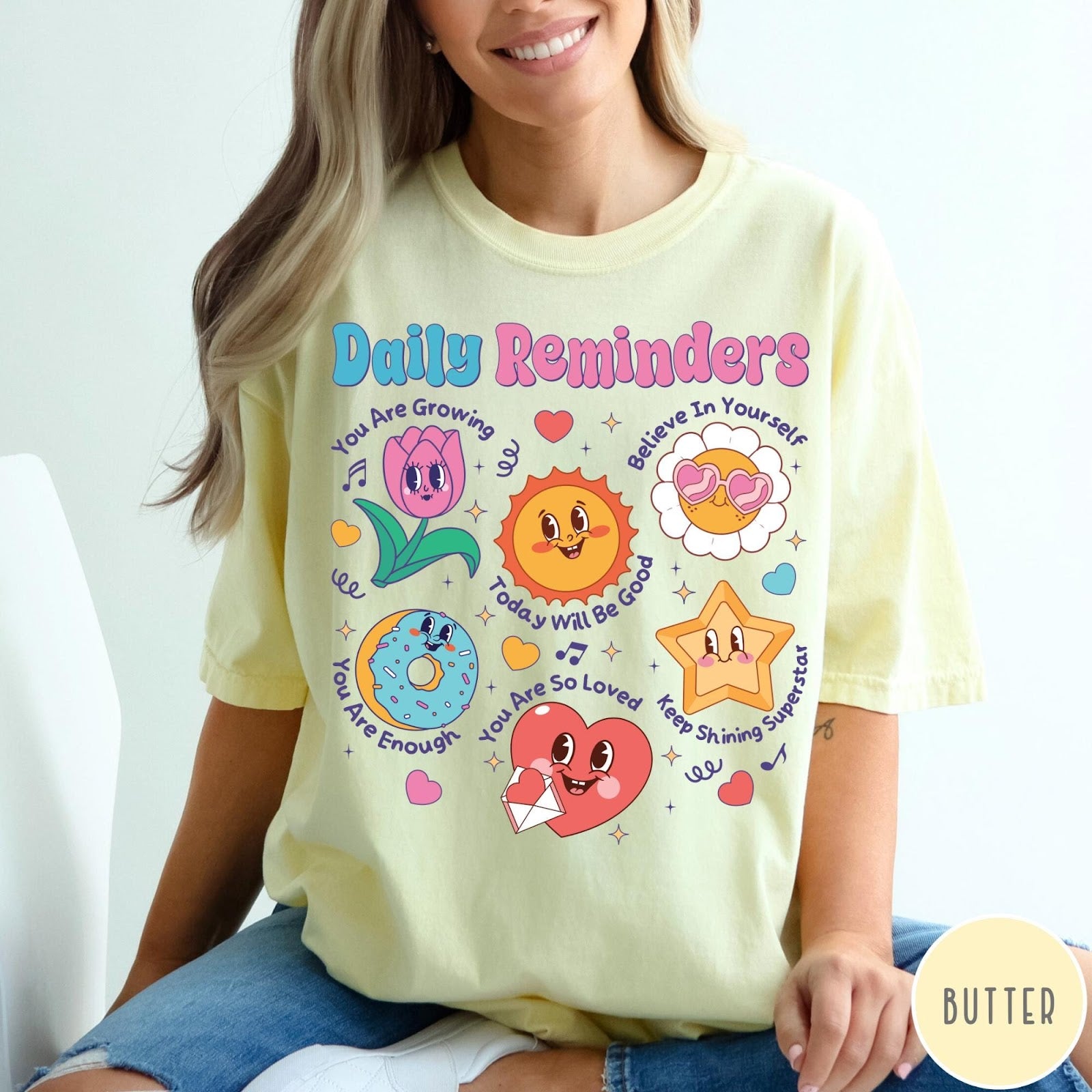 Comfort Colors tee in Butter featuring retro mascot graphic with daily affirmations and cute cartoon characters