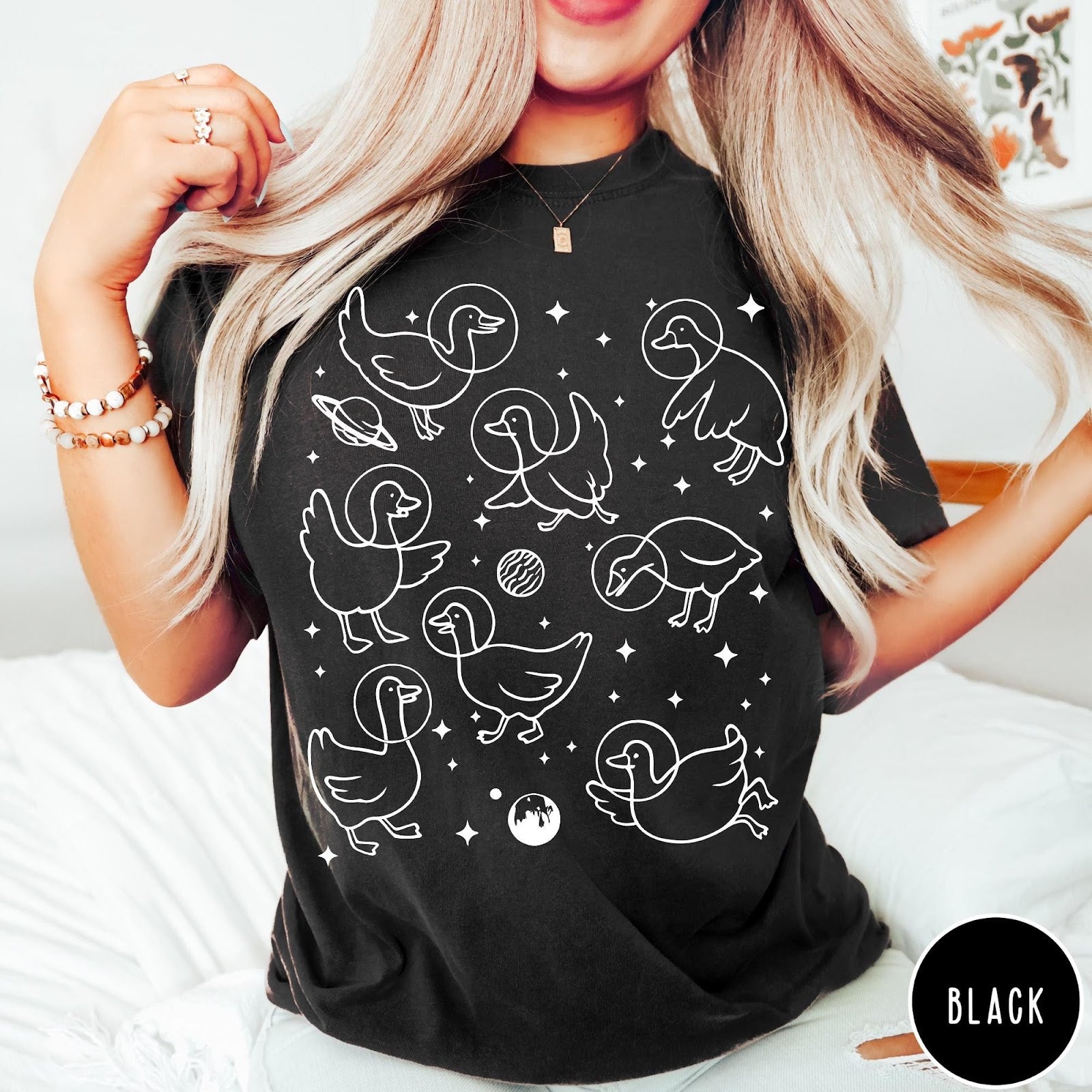 Comfort Colors tee in Black featuring line art graphic of multiple geese wearing astronaut helmets in space