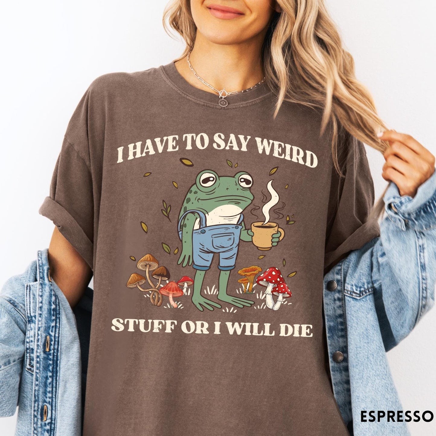 Comfort Colors tee in Espresso featuring illustrative frog graphic with coffee cup and various forest mushrooms