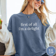 Comfort Colors tee in Blue Jean featuring typography graphic reading first of all i'm a delight in white