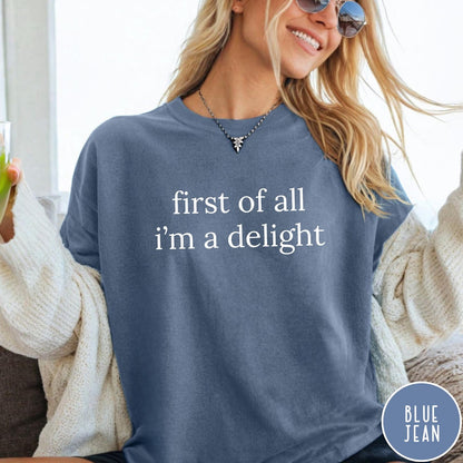 Comfort Colors tee in Blue Jean featuring typography graphic reading first of all i'm a delight in white