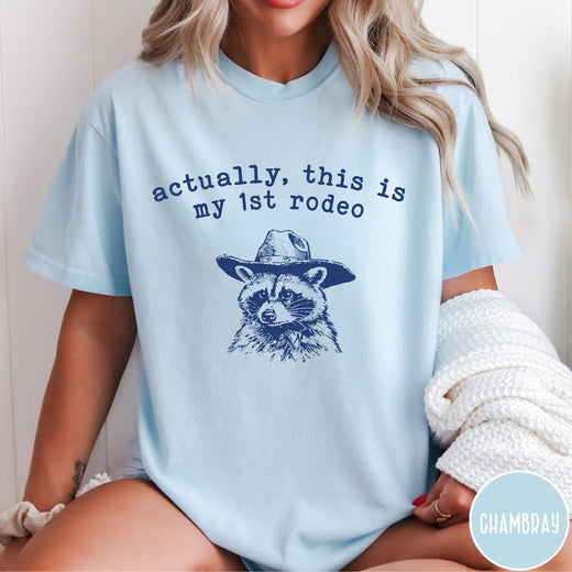 Comfort Colors tee in Chambray featuring western style graphic of a raccoon wearing a cowboy hat