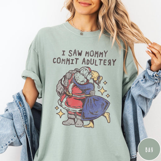 Comfort Colors tee in Bay featuring vintage style graphic of Santa Claus kissing a woman under stars