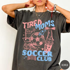 Comfort Colors tee in Pepper featuring soccer mom life graphic with soccer ball, whistle, and iced coffee