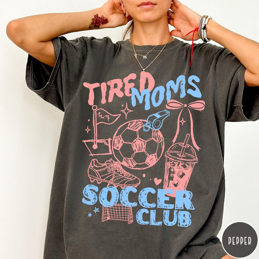 Comfort Colors tee in Pepper featuring soccer mom life graphic with soccer ball, whistle, and iced coffee