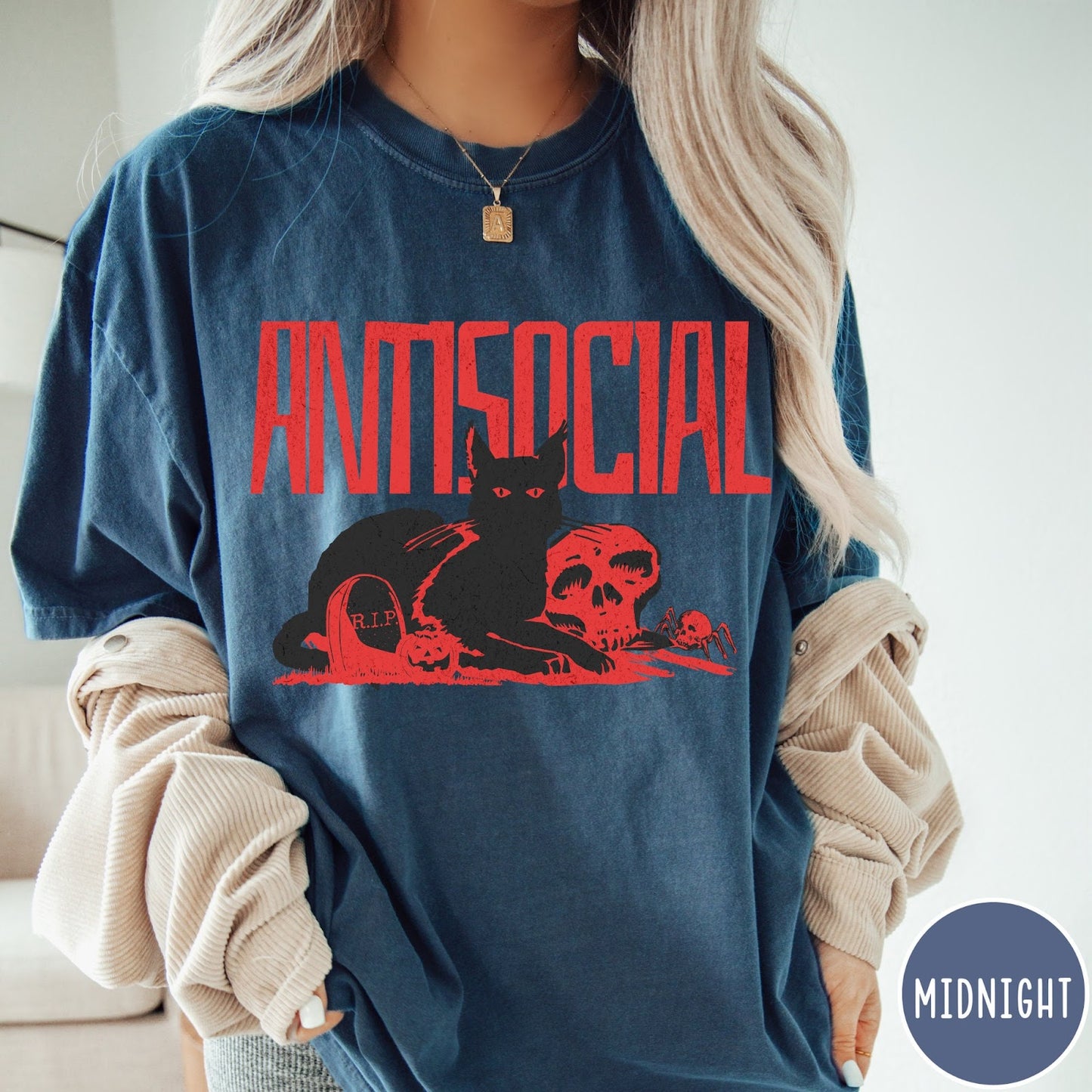 Comfort Colors tee in Midnight featuring retro graphic design of a black cat with skull and tombstone