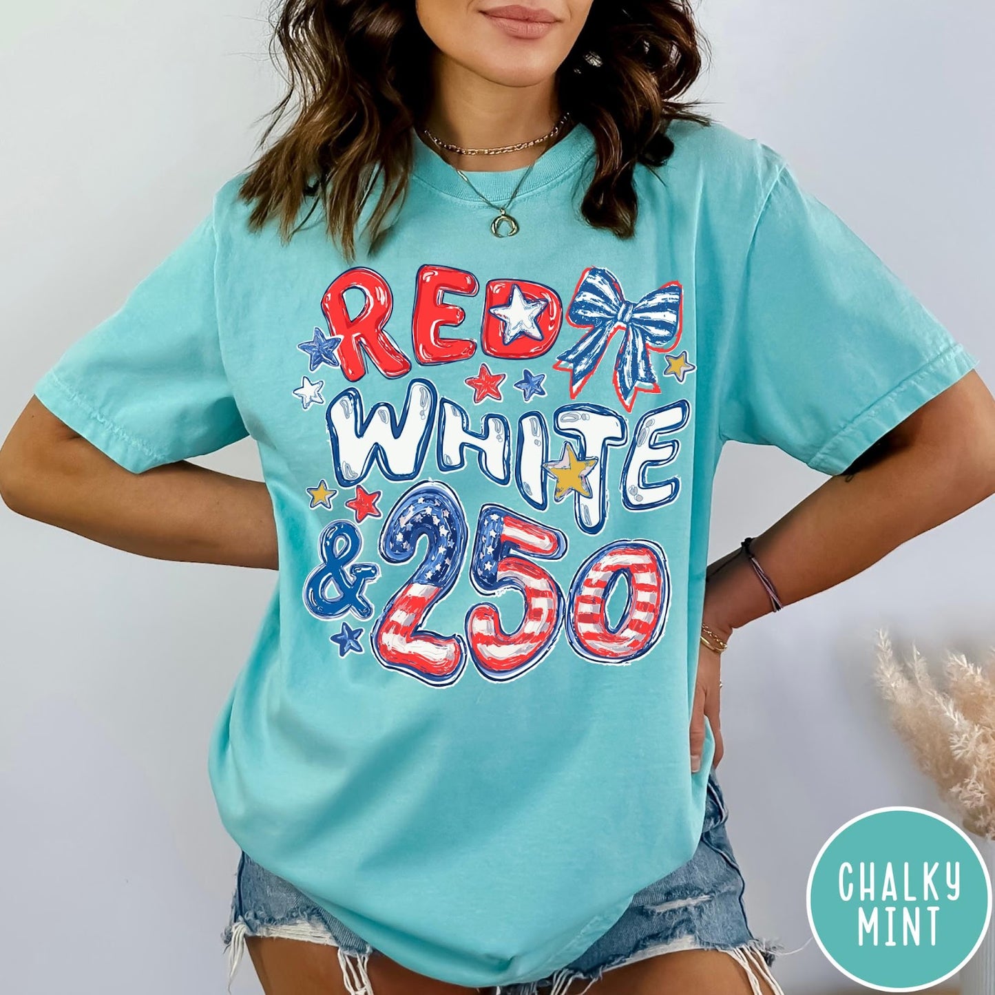 Comfort Colors tee in Chalky Mint featuring patriotic 250th anniversary graphic with red white and blue stars and bow