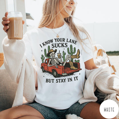 Comfort Colors tee in White featuring western skeleton design with cowboy hat and boots in truck bed