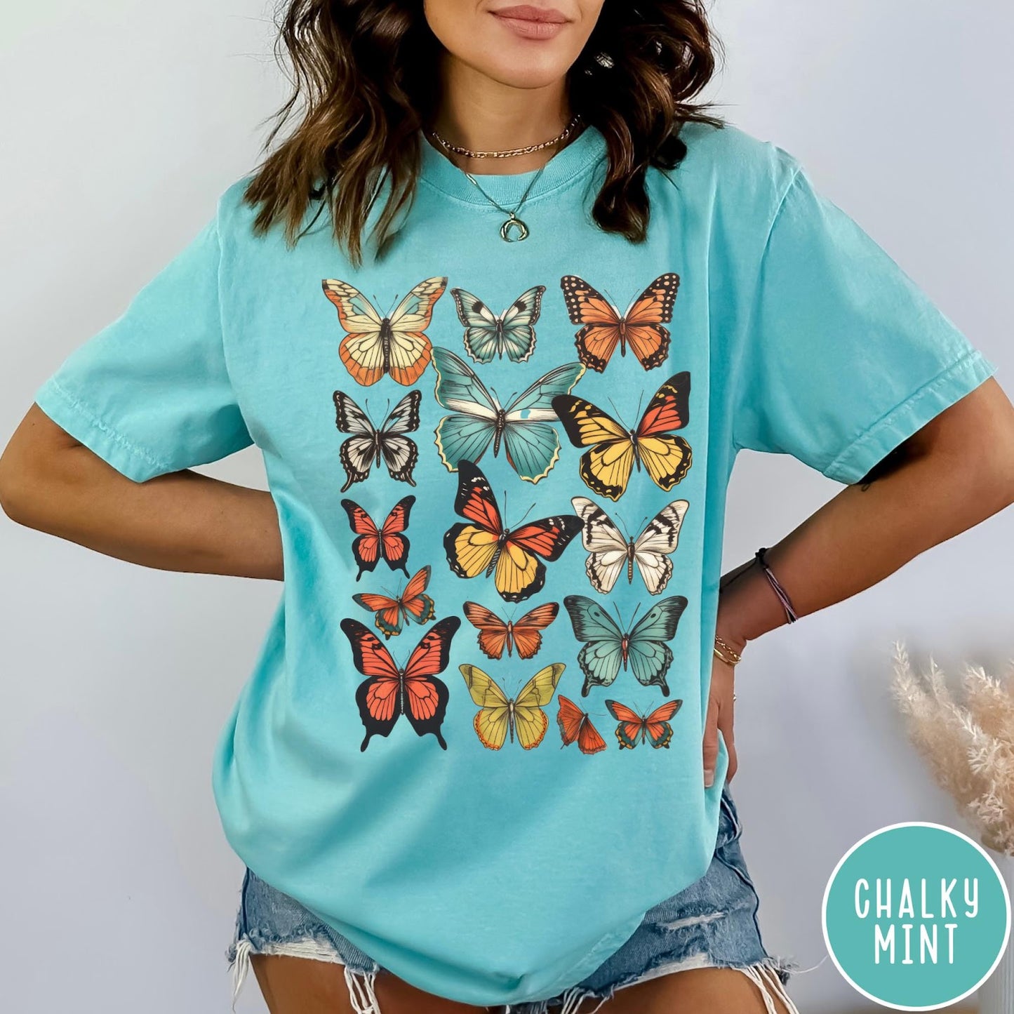 Comfort Colors tee in Chalky Mint featuring butterfly collection design with various colorful butterfly illustrations in a grid