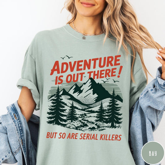 Comfort Colors tee in Bay featuring mountain and tree graphic with adventure and serial killer text design