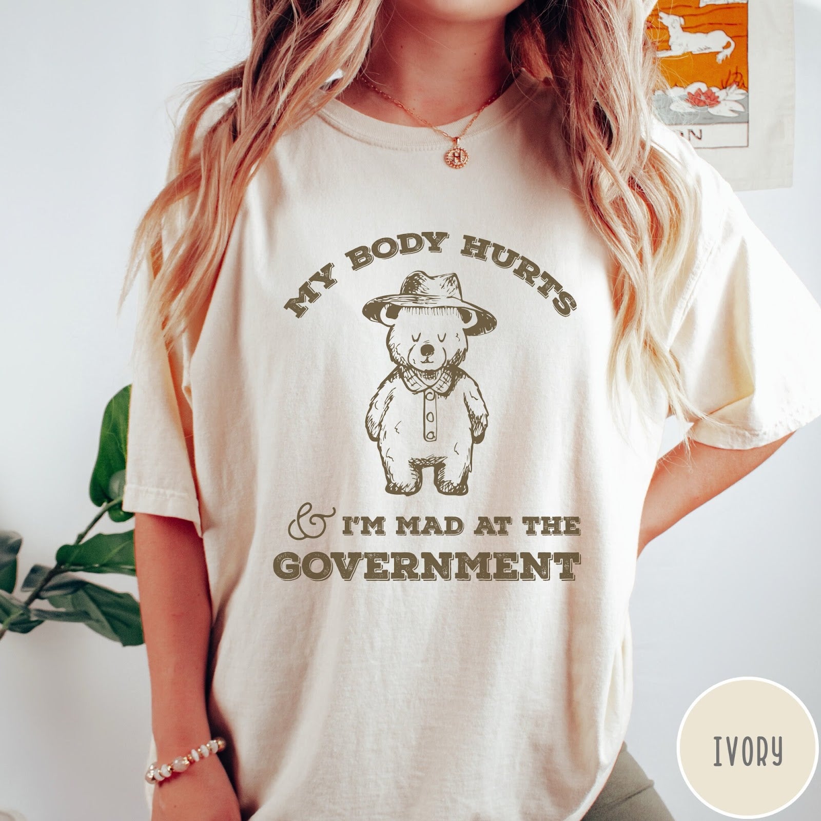 Comfort Colors tee in Ivory featuring line art style bear wearing a hat and button-up shirt graphic
