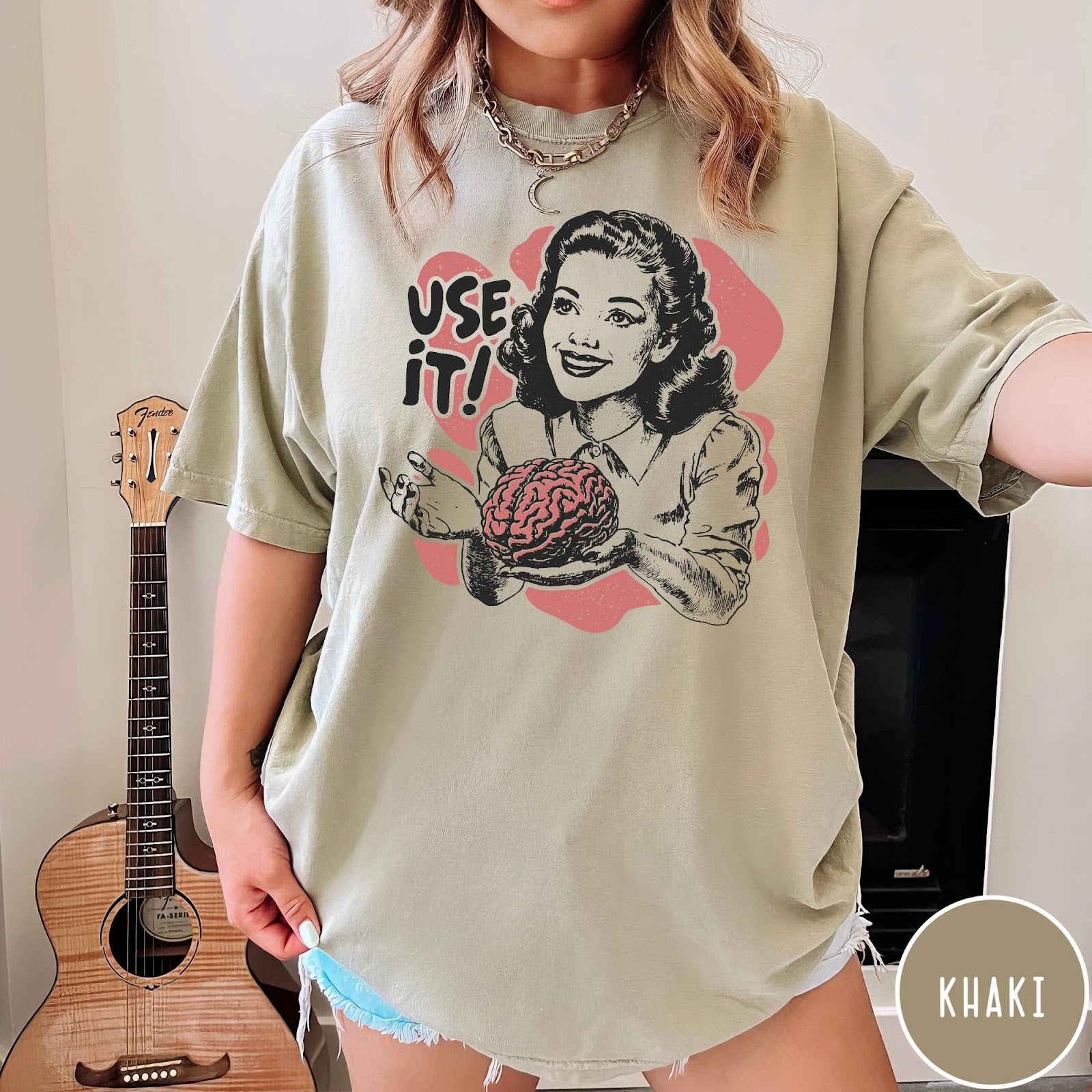 Comfort Colors tee in Khaki featuring retro design of a woman holding a brain with text Use It