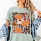 Comfort Colors tee in Bay featuring boho floral style graphic with three orange pumpkins and brown flowers