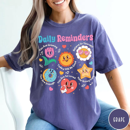 Comfort Colors tee in Grape featuring retro mascot graphic with daily affirmations and cute cartoon characters
