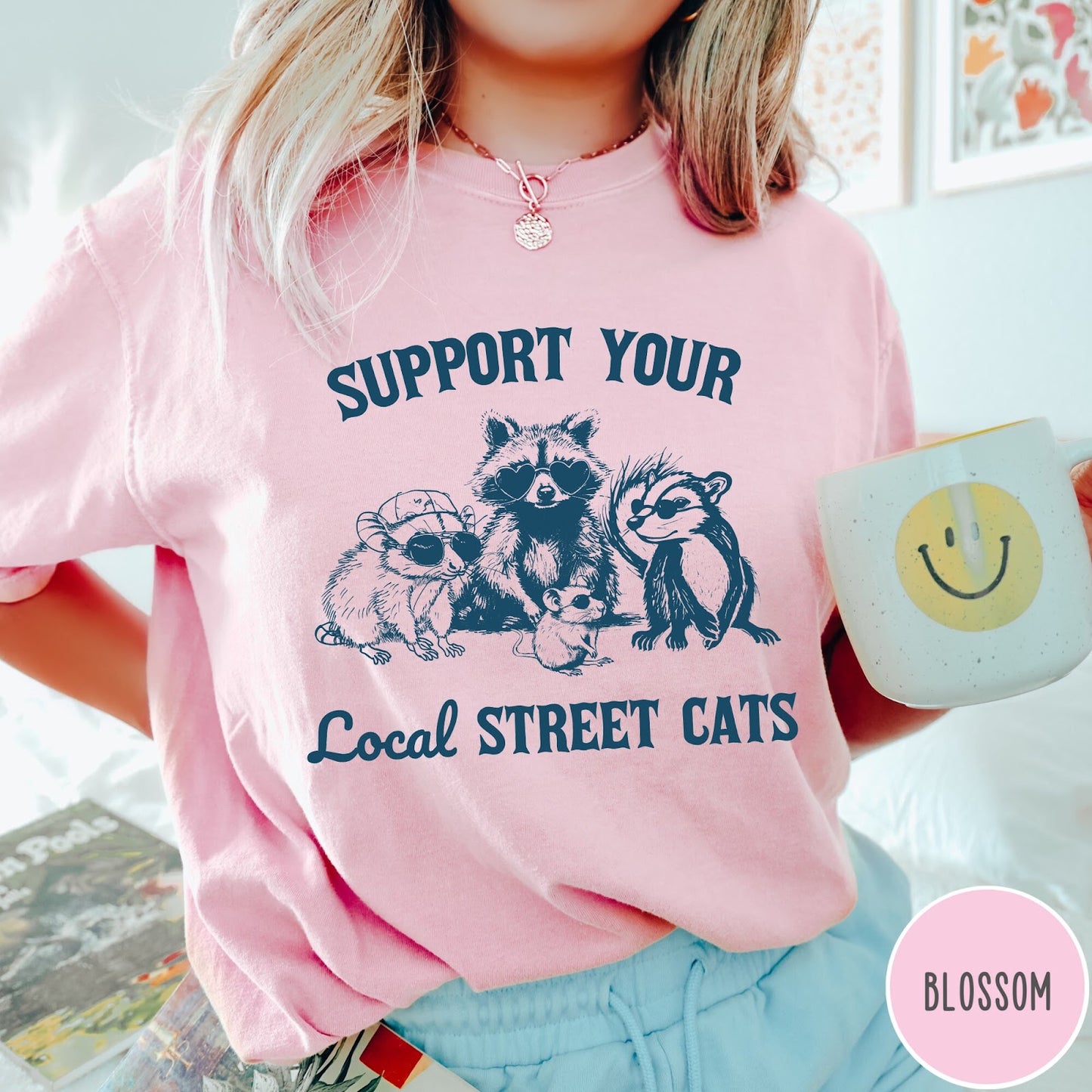 Comfort Colors tee in Blossom featuring illustration style graphic of a raccoon, opossum, and skunk wearing sunglasses