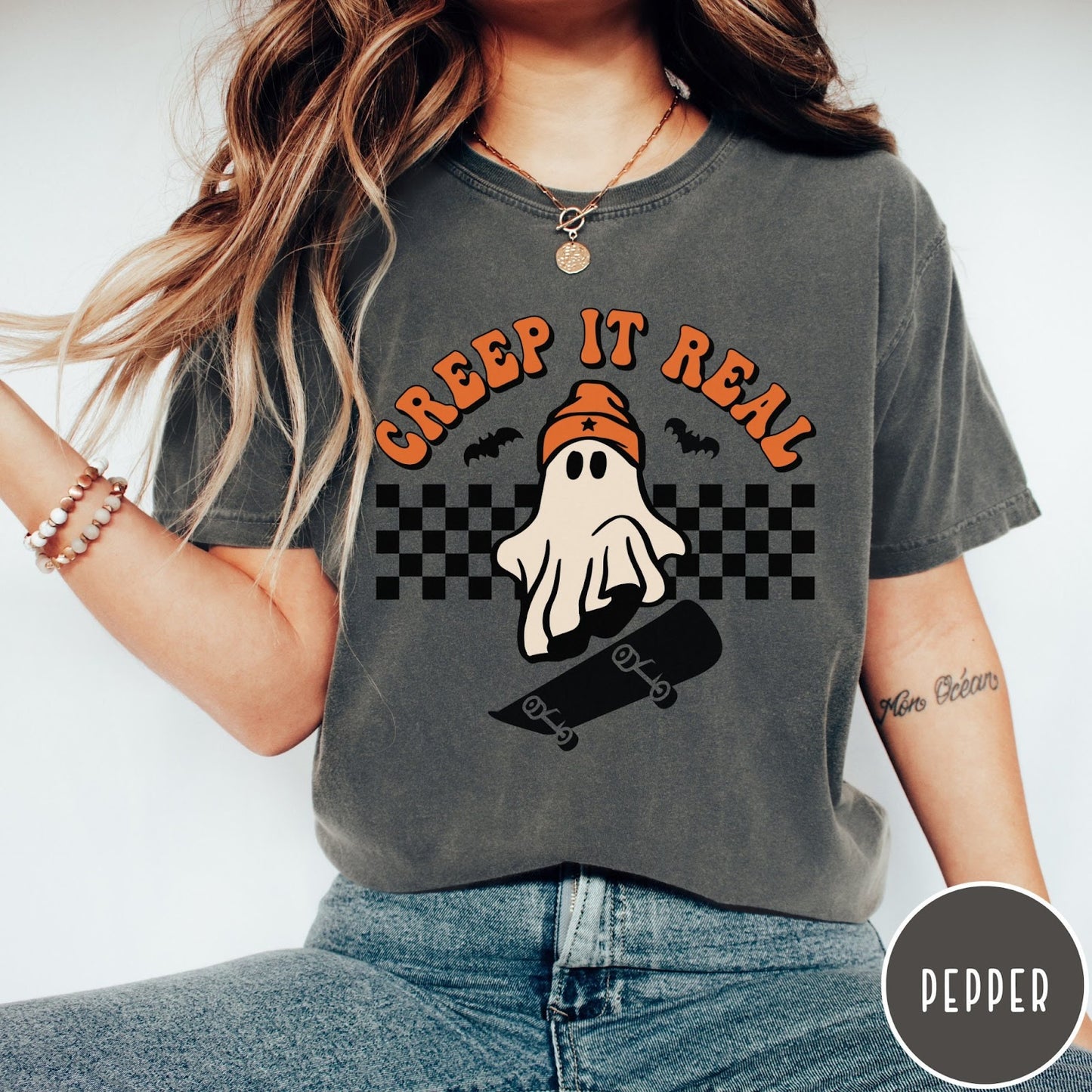 Comfort Colors tee in Pepper featuring retro style ghost graphic with skateboard and checkered background pattern