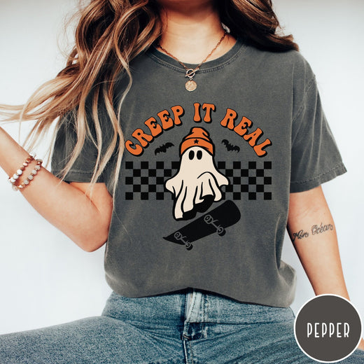 Comfort Colors tee in Pepper featuring retro style ghost graphic with skateboard and checkered background pattern