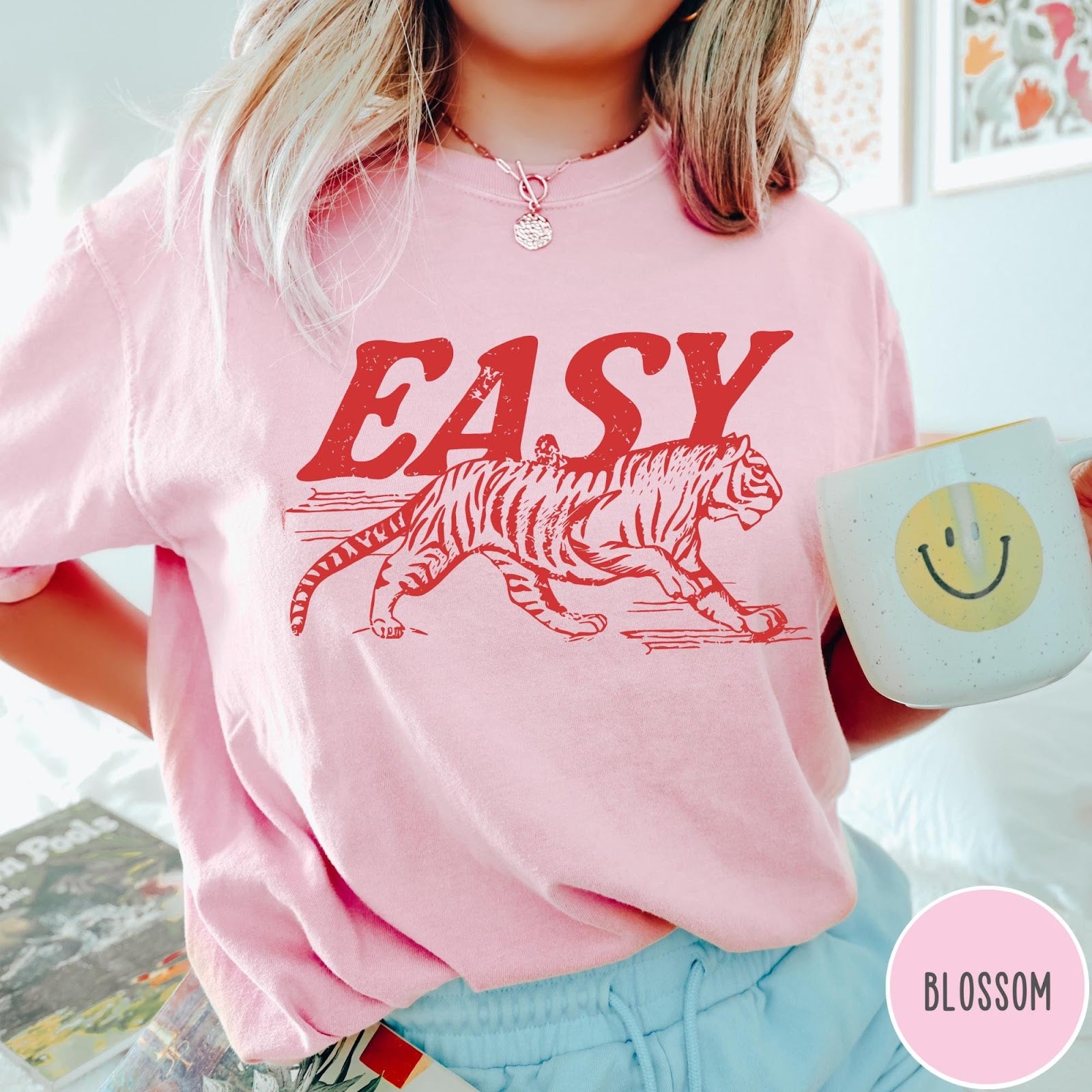 Comfort Colors tee in Blossom featuring vintage style graphic of a walking tiger and text Easy
